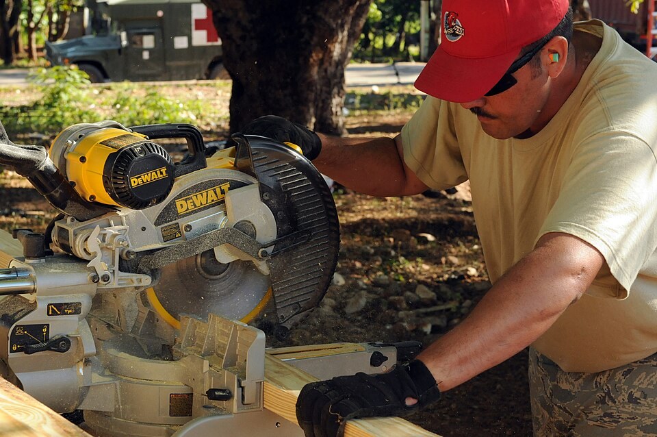 Woodworker using a sliding miter saw